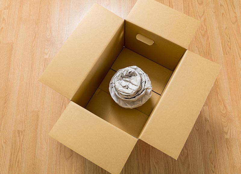 Movers and packers labeling boxes clearly to ensure easy unpacking during a move.